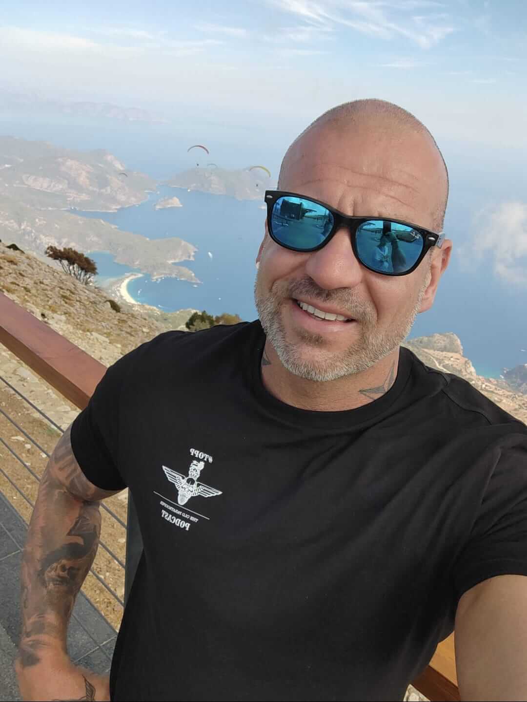 Selfie of a man wearing a podcast t-shirt