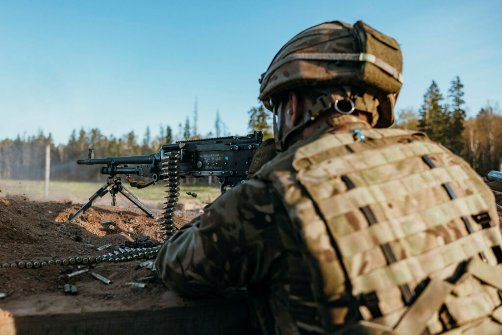 Veteran holding a gun in a firing range.
